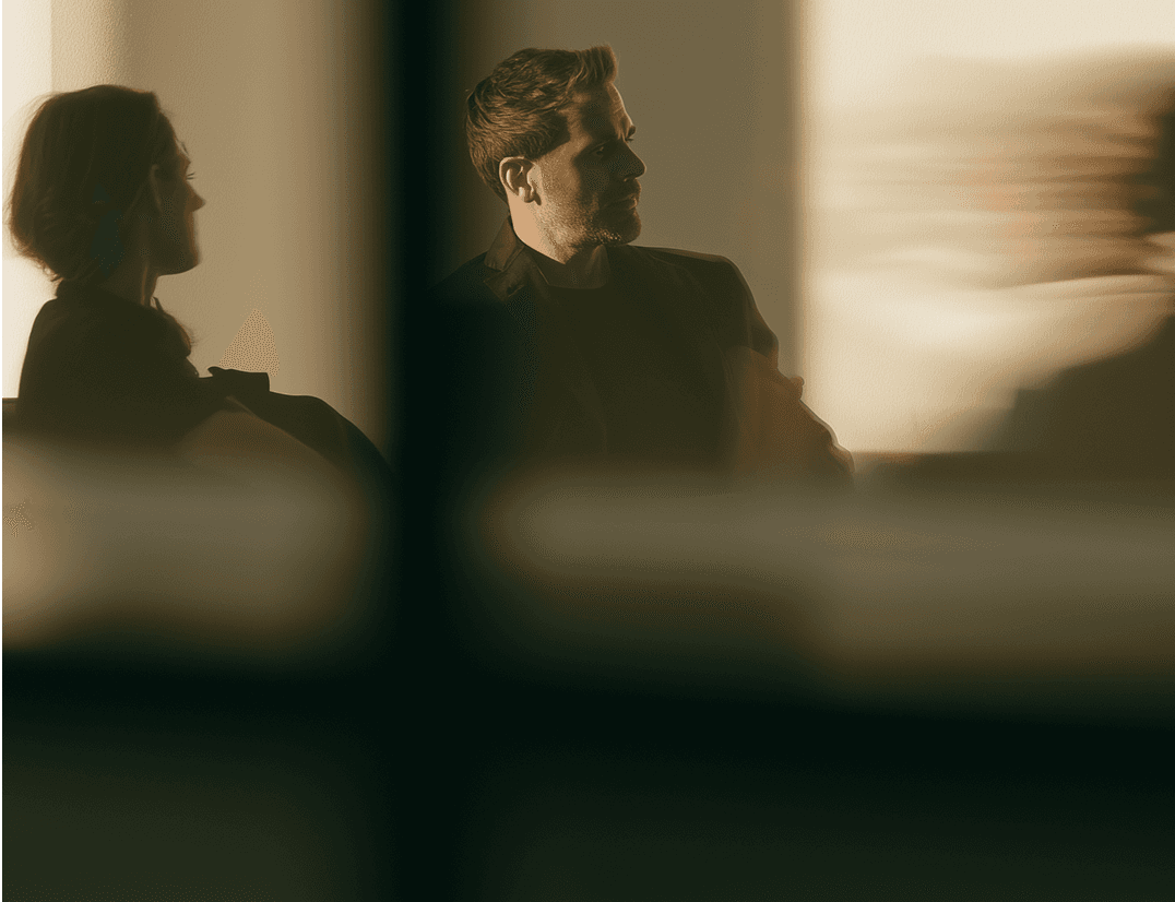 Two colleagues in silhouette against a sunlit wall